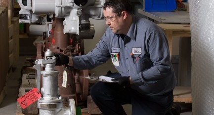 contro valve employee inspecting a valve